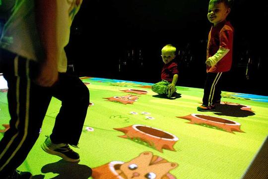 Children play a game of whack-a-mole in an interactive video effect game room at Sioux City's LaunchPAD Children's Museum. The FX Game Zone -- which opened last month -- features nearly 160 games that allow kids to run around and have fun.
Justin Wan, Sioux City Journal